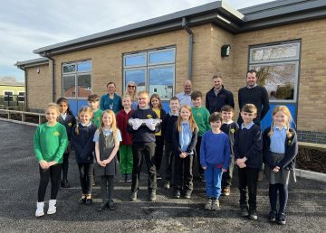 R G Carter with staff and pupils at Watton Junior School with time capsule