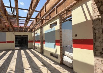 Exposed roof beams and stripped‑out interior during refurbishment works at the Oswald Building, Abbey College Ramsey.