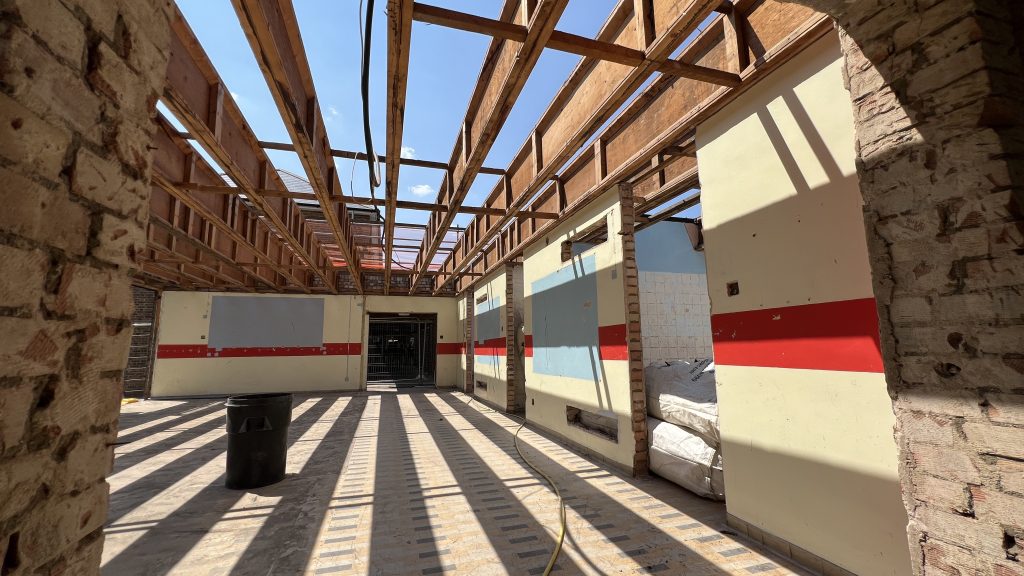 Exposed roof beams and stripped‑out interior during refurbishment works at the Oswald Building, Abbey College Ramsey.