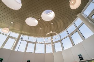 Interior architectural features including circular skylights and suspended lighting.