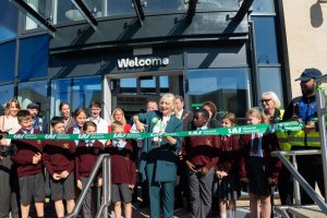 Community members and schoolchildren attend the official opening ceremony.